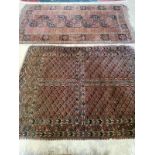 An Afghan red ground rug, 190 x 107cm together with a Turkoman red ground rug, 158 x 122cm