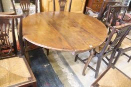 An 18th century mahogany oval drop-flap dining table, length 134cm extended, width 120cm, height