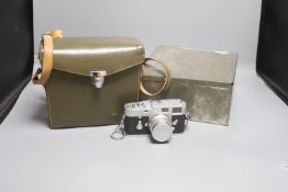 A Leica M2 camera, serial no. 1069469 with 2 lenses Elmarit 90mm F2.8 no. 1918216 and Summaron