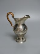 An Edwardian silver cream jug, with rattan handle, Goldsmiths & Silversmiths Co Ltd, London, 1909,