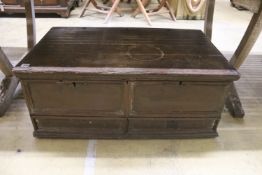 An 18th century oak trunk with dummy drawer front, width 92cm, depth 53cm, height 39cm