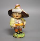 A Derby model of a Mansion Dwarf, modelled as a portly man wearing a large brimmed hat with a menu