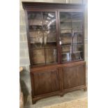 A George III mahogany bookcase cupboard, length 160cm, depth 40cm, height 245cm
