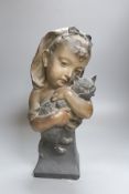 A plaster bust of a girl holding a cat, stamped CM, numbered 467, height 41cm