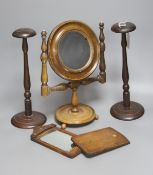 A 19th century walnut shaving mirror, height 31cm, two mahogany wig stands and a travelling mirror