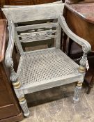 A pair of Dutch colonial style painted cane seat dining chairs, width 55cm, depth 50cm, height 86cmA