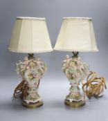 A pair of German porcelain flower encrusted lamps, height 24cm