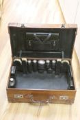 A gentleman's brown leather cased silver travelling vanity set, with silver lidded bottles interior,