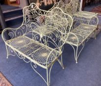 A French painted wrought iron garden suite comprising a pair of benches, length 122cm, depth 62cm,