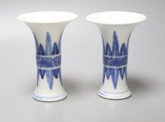 A pair of Chinese blue and white small beaker vases, Kangxi mark but c.1900, height 12cm