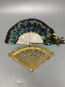 An early 20th century peacock? feather and mother of pearl fan and an early 19th century French