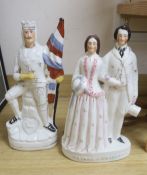 A large Staffordshire group of a prince and princess, and a military figure with a flag, tallest