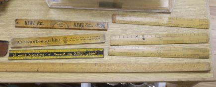 A group of rules and measures including three advertising rulers, longest 114cm