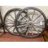 A pair of Victorian iron mounted spoked cart wheels, 70cm diameter