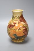 A small Moorcroft peaches and finch pattern vase, height 20cm