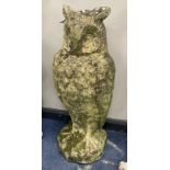A reconstituted stone garden ornament modelled as an owl, height 70cm