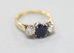 A sapphire and diamond three-stone ring, 18ct gold and platinum setting, size K, gross 3.3 grams.