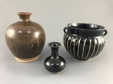 A Chinese blackware ribbed jar, a small blackware vase and a russet and black glazed jar, Yuan