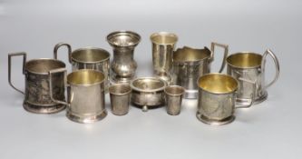 A group of six Russian early 20th century 84 zolotnik podstakanniks, two small vases, two tots and a