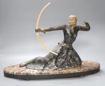 An Art Deco style spelter and marble figure of a female archer, base length 55cm