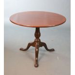 A George III mahogany tea table,with tilting circular top on birdcage stem and tripod base,Diam.