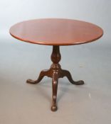 A George III mahogany tea table,with tilting circular top on birdcage stem and tripod base,Diam.