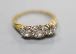 A yellow metal and three stone diamond ring, size L, gross weight 3.3 grams,total diamond weight