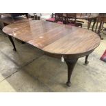 A 1920's circular mahogany extending dining table with three leaves and handle, length approx. 230cm