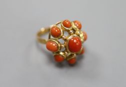 A yellow metal and nine stone coral bead cluster set dress ring, size O, gross 9.1 grams.