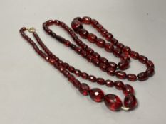 Two transluscent single strand simulated cherry amber bead necklaces, longest 82cm, gross weight 120