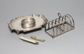 A George V silver seven bar toastrack, a silver inkstand(no well) and two mother of pearl handled