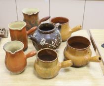 Six vintage Continental, probably French, glazed stoneware cooking pots and a slip-decorated
