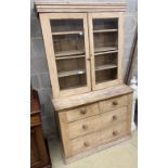 A Victorian glazed pine cabinet on chest, width 112cm, depth 50cm, height 195cm