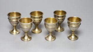 A set of six George III demi-fluted silver egg cups, John Scofield, London, 1797, height 7cm, 9oz.