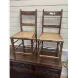 A pair of George V Coronation chairs stamped with Royal Cypher