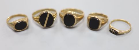 Four assorted modern 9ct gold and black onyx set signet rings and one other similar ring, largest