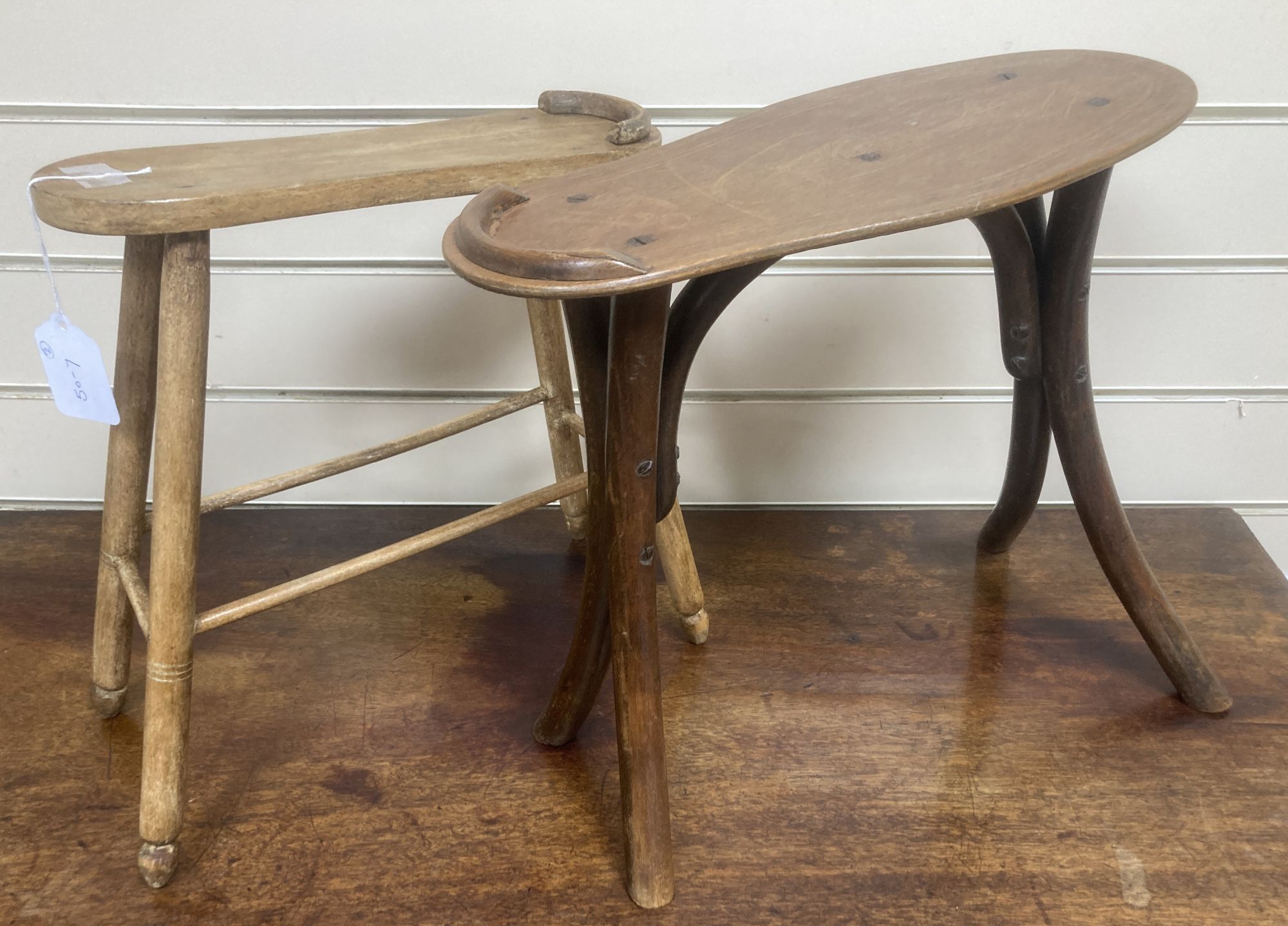 Two early 20th century treen shoe rests, larger 36cm wide, 35cm high