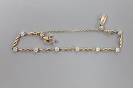 A modern 10k yellow metal and diamond chip set flower head bracelet, approx. 18cm, gross 5.3 grams.