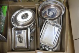 Three silver plated entree dishes with covers and handles and a group of assorted entree dishes,