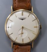 A gentleman's late 1950's 9ct gold Longines manual wind wrist watch, on a leather strap, case