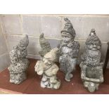 Six reconstituted stone gnome garden ornaments, largest 60cm high