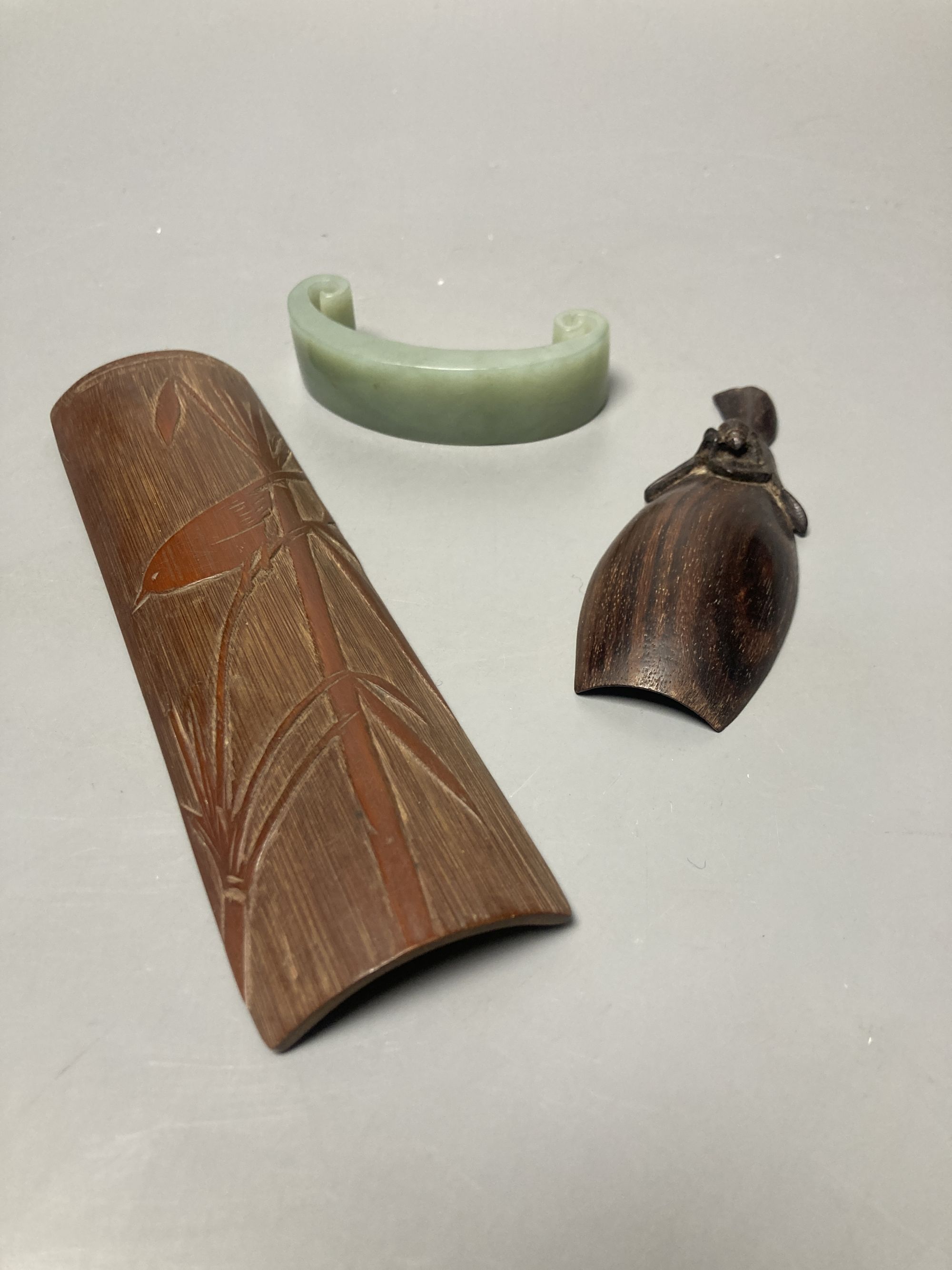 A Japanese bamboo wrist wrest, a Chinese jadeite, bamboo scoop and wooden carving possibly Zitan,