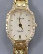 A lady's modern 9ct gold and diamond set Tissot Saphir quartz? wrist watch, 18.5cm,gross 26.2