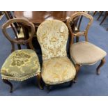 A Victorian ebonised and gilt upholstered nursing chair and pair of balloon back chairs