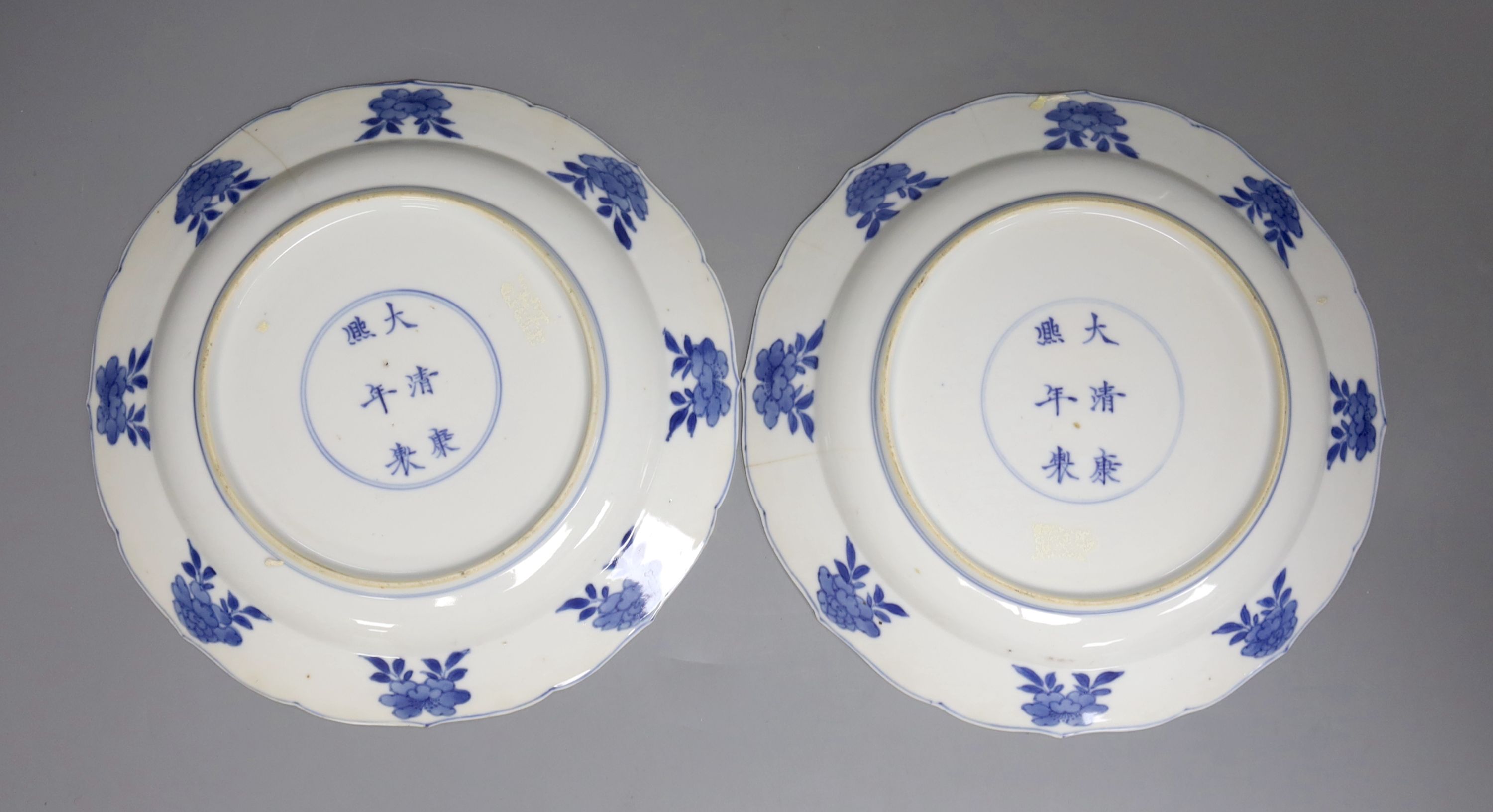 A pair of Chinese blue and white porcelain plates, Kangxi mark and period, with shaped borders and - Image 2 of 2