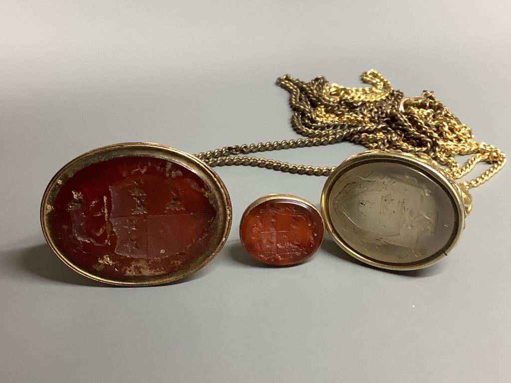 Three assorted 19th century yellow metal overlaid and carnelian set fob seals, two on gilt metal