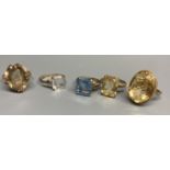 Four assorted modern 9ct gold and gem set rings, including citrine and smoky quartz and a similar