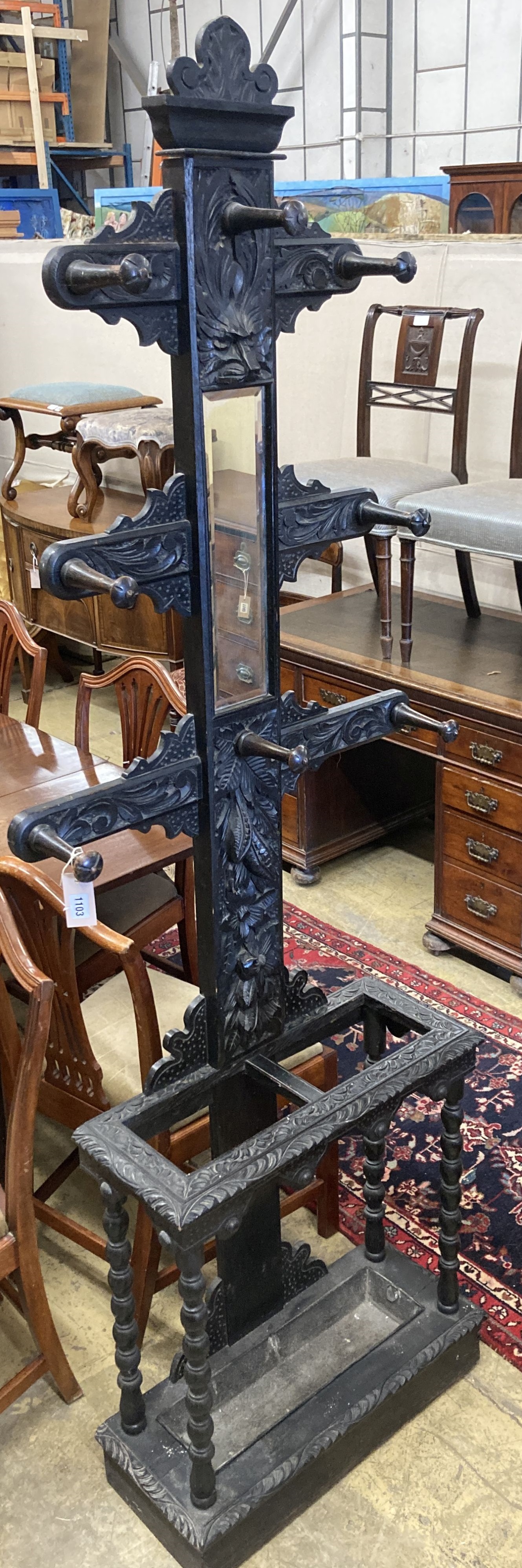 An early 20th century Flemish carved oak hall stand, width 60cm, depth 25cm, height 208cm