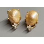 A modern pair of 18k yellow metal, baroque pearl and four stone diamond chip set ear clips, 21mm,