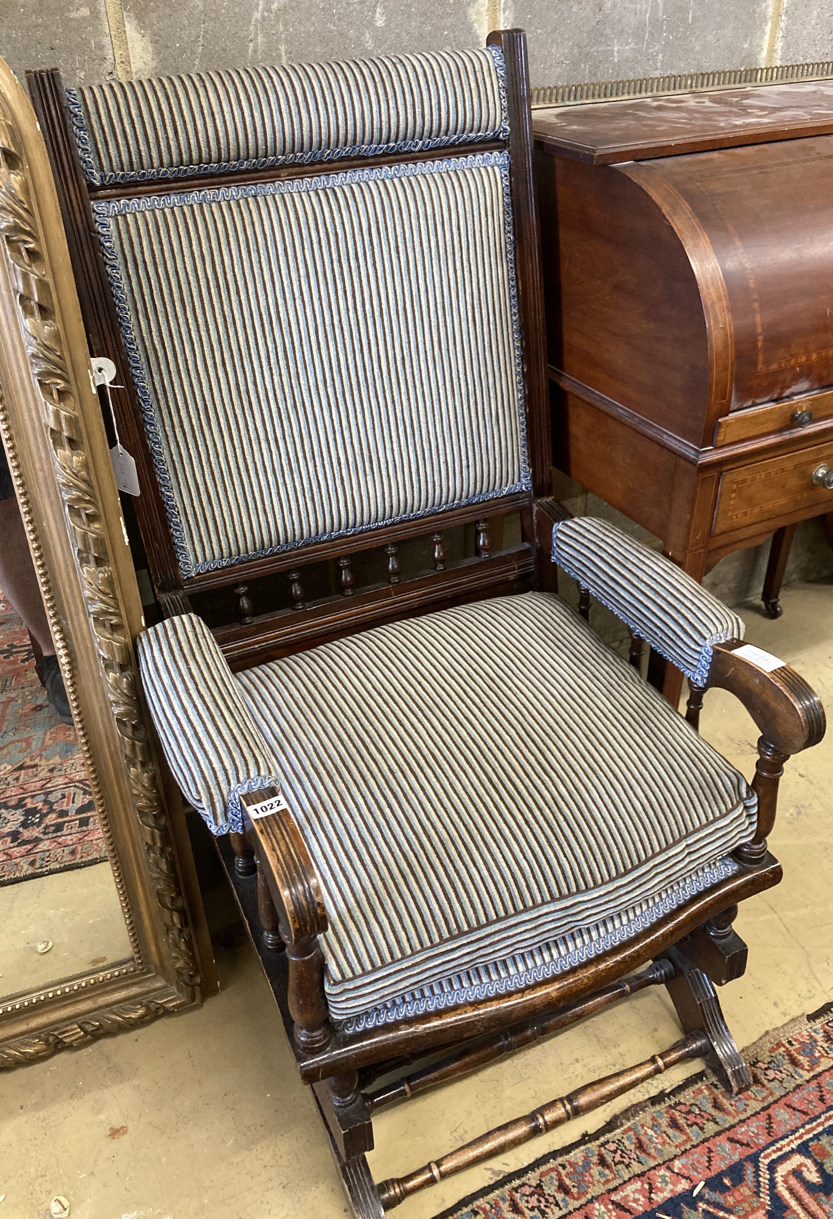 An early 20th century American mahogany rocking chair, width 60cm, depth 52cm, height 108cm